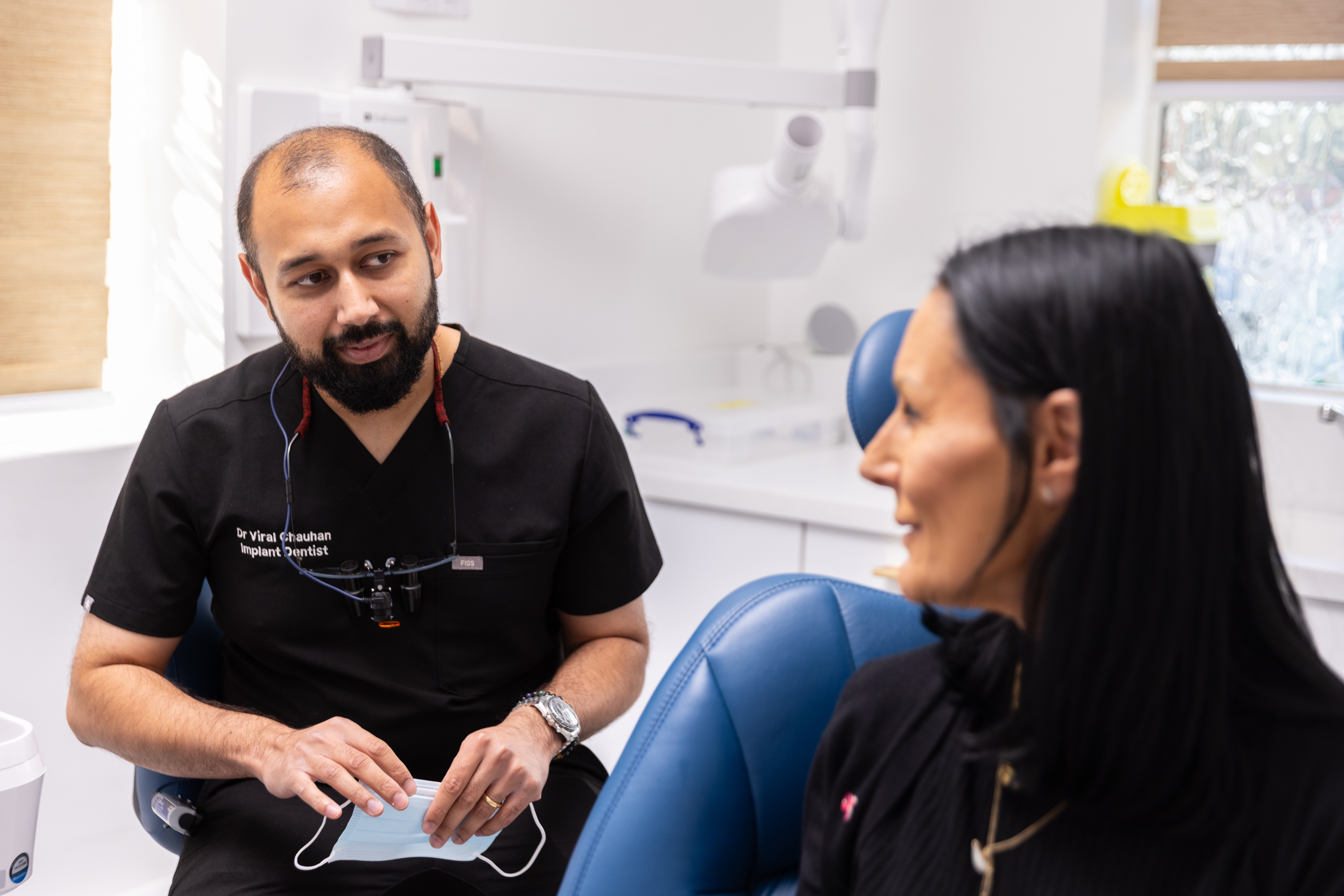 Dr Viral Chauhan in consultation with a patient